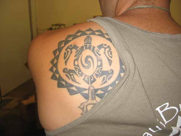 shoulder blade tattoo. on his left shoulder blade