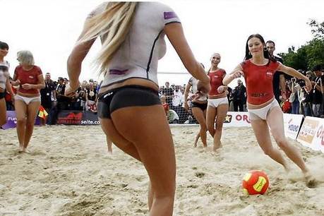 Bodypainted beach babes doing beach soccer game Bodypainted beach babes doing beach soccer game