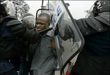 Riot police beat protester in Kinshasa